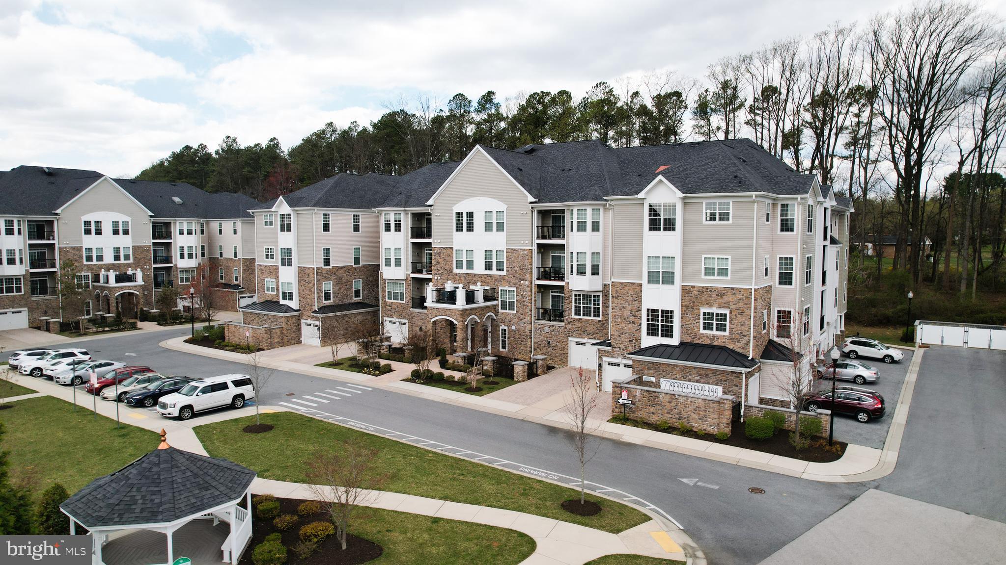 620 Quarry View Court, Unit 407 Reisterstown, MD 21136 - Photo 1 of 25 a view of multiple houses with a swimming pool and furniture
