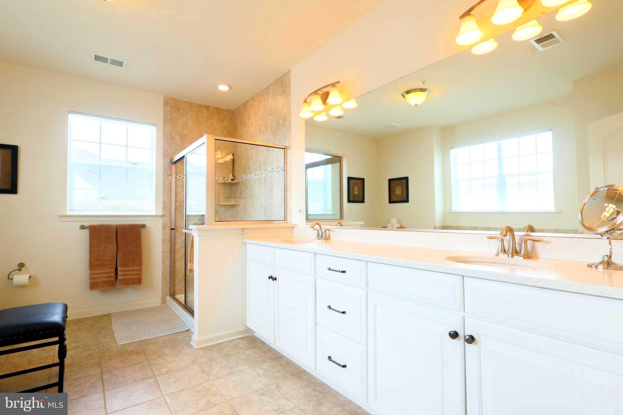 620 Quarry View Court, Unit 407 Reisterstown, MD 21136 - Photo 13 of 25 a spacious bathroom with a granite countertop sink mirror and a bathtub