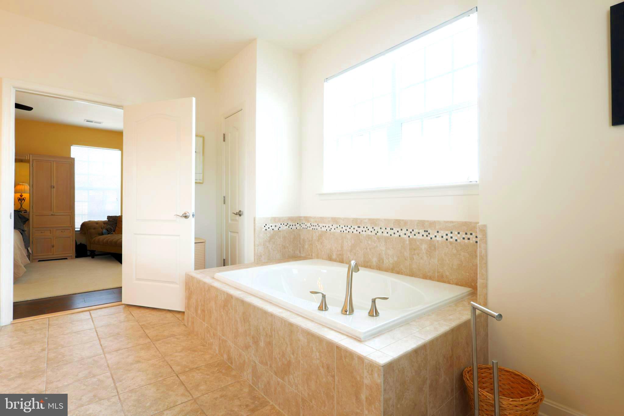 620 Quarry View Court, Unit 407 Reisterstown, MD 21136 - Photo 15 of 25 a bathroom with a tub and a shower