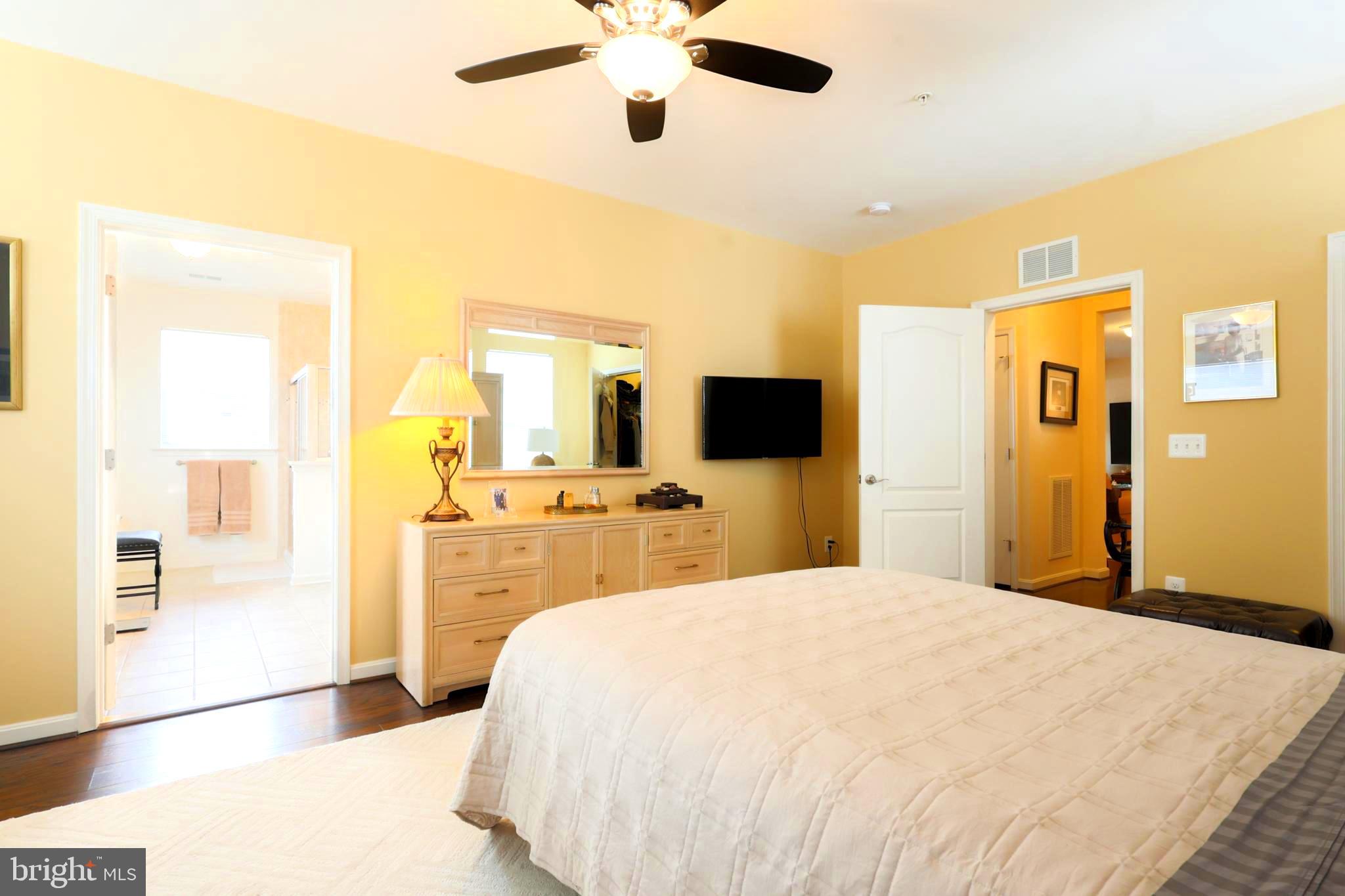 620 Quarry View Court, Unit 407 Reisterstown, MD 21136 - Photo 17 of 25 a bedroom with a bed and a flat tv screen on dresser