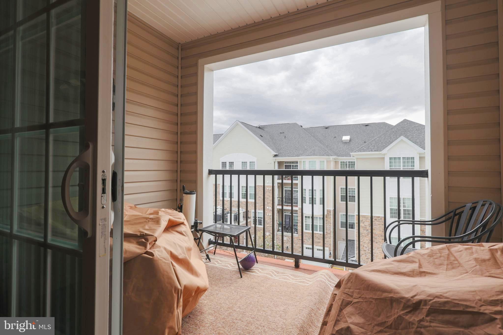620 Quarry View Court, Unit 407 Reisterstown, MD 21136 - Photo 22 of 25 a bedroom with a bed and a large window with outer view