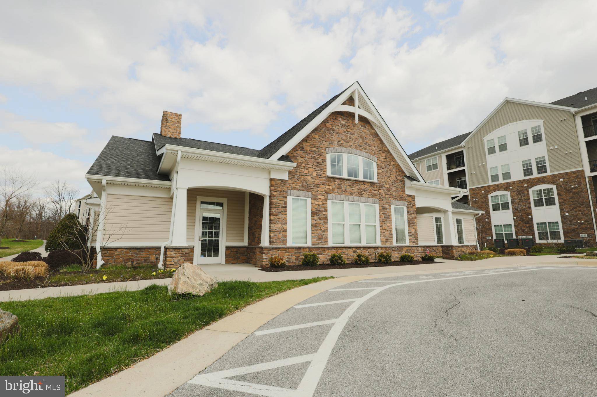 620 Quarry View Court, Unit 407 Reisterstown, MD 21136 - Photo 23 of 25 a front view of a house with a yard