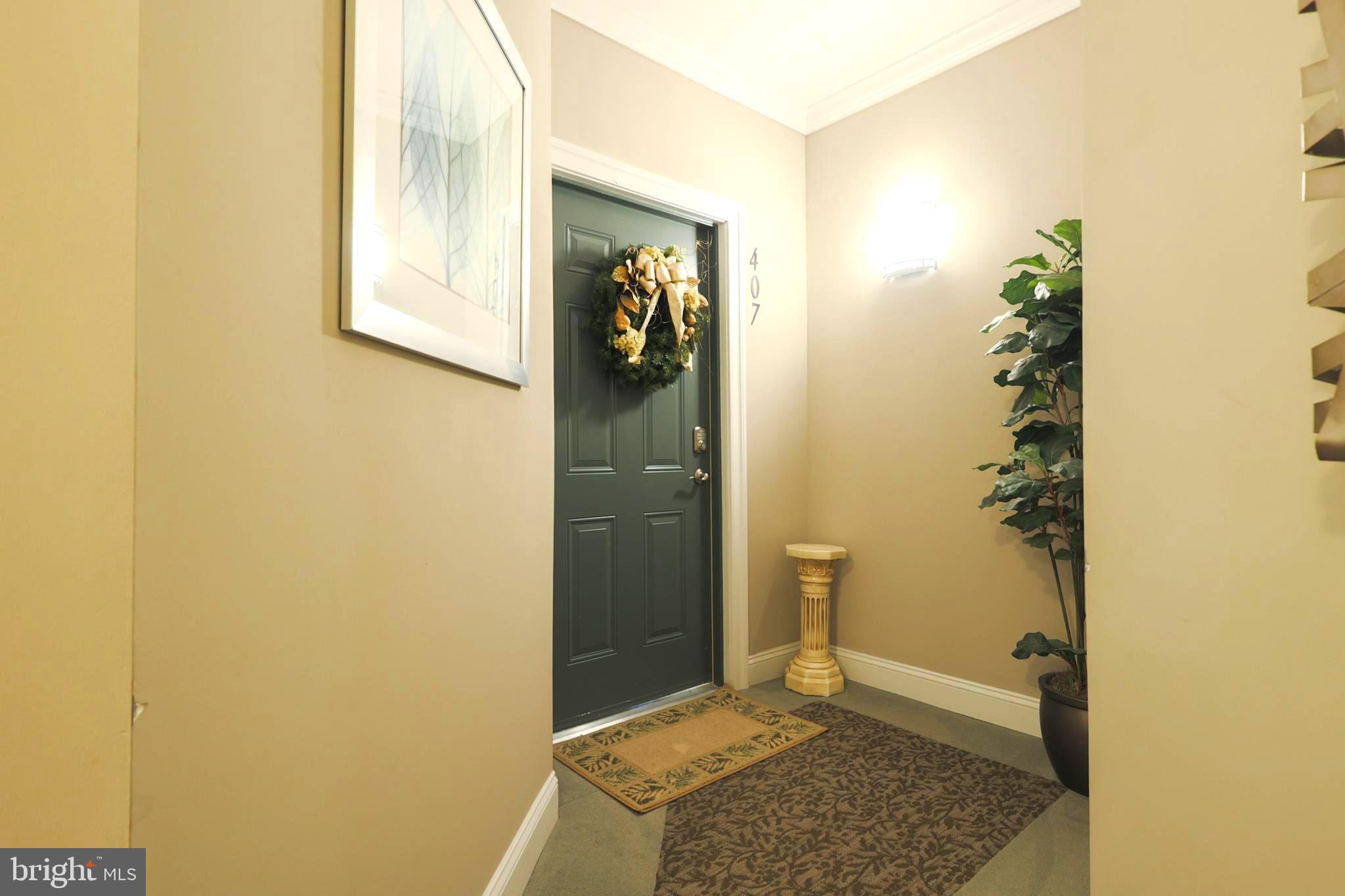 620 Quarry View Court, Unit 407 Reisterstown, MD 21136 - Photo 3 of 25 a view of livingroom with hallway and mirror