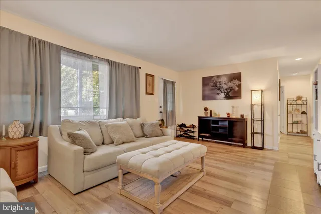 a living room with furniture a large window and a flat screen tv