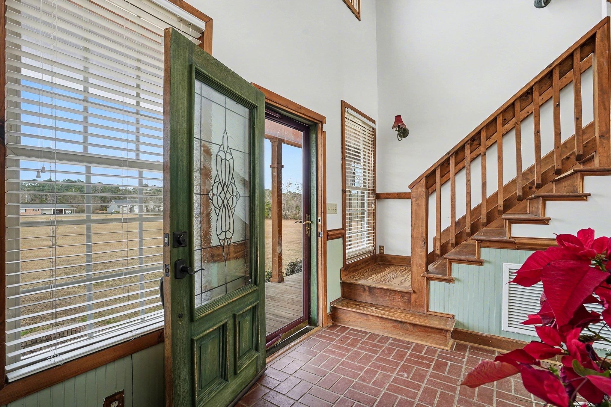 202 Highway 747 Loris Sc 29569 Loris, SC 29569 - Photo 13 of 34 Foyer entrance featuring brick flooring and stairway
