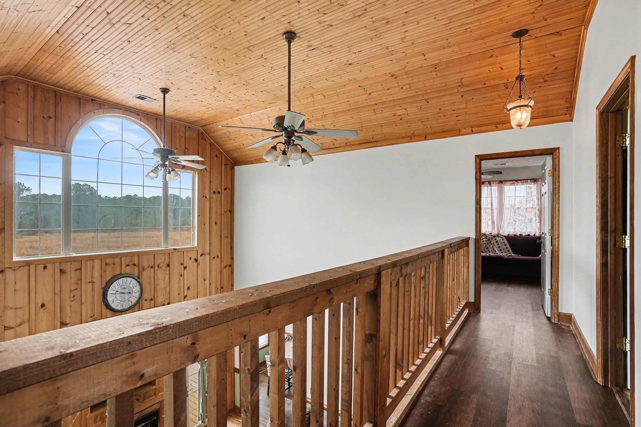 202 Highway 747 Loris Sc 29569 Loris, SC 29569 - Photo 14 of 34 Hall featuring vaulted ceiling, wooden ceiling, wood walls, and dark wood finished floors