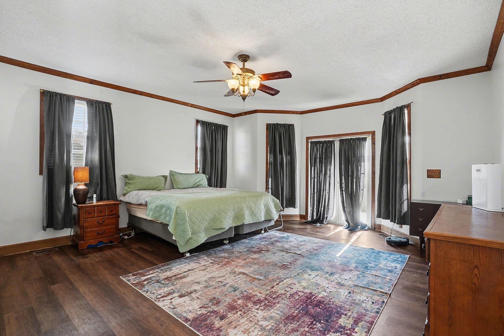 202 Highway 747 Loris Sc 29569 Loris, SC 29569 - Photo 16 of 34 Bedroom with a ceiling fan, a textured ceiling, ornamental molding, and dark wood-style flooring