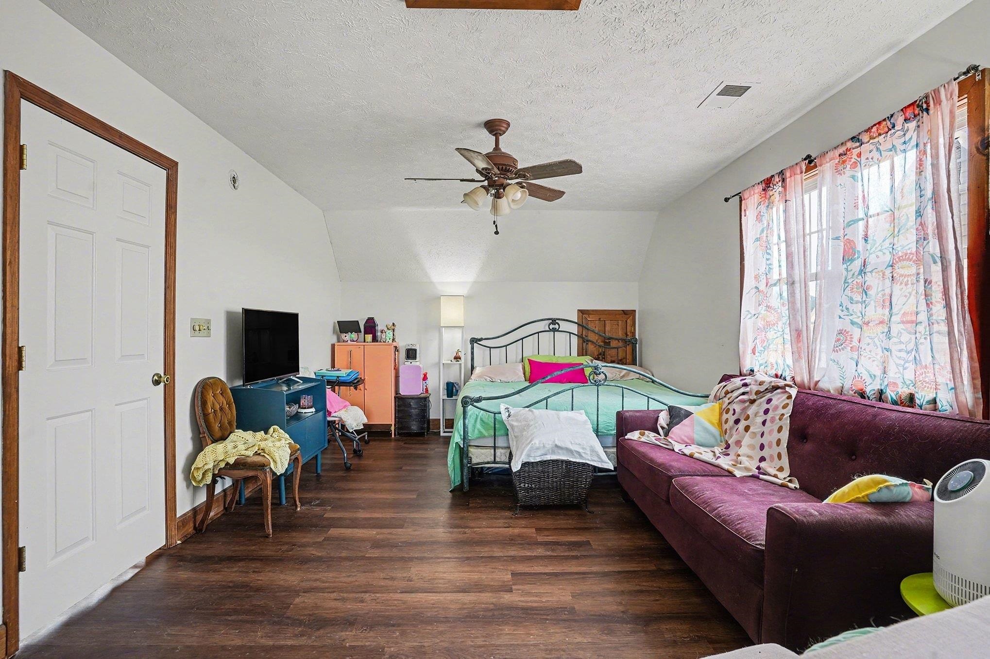 202 Highway 747 Loris Sc 29569 Loris, SC 29569 - Photo 21 of 34 Bedroom with dark wood-type flooring, a textured ceiling, ceiling fan, and vaulted ceiling