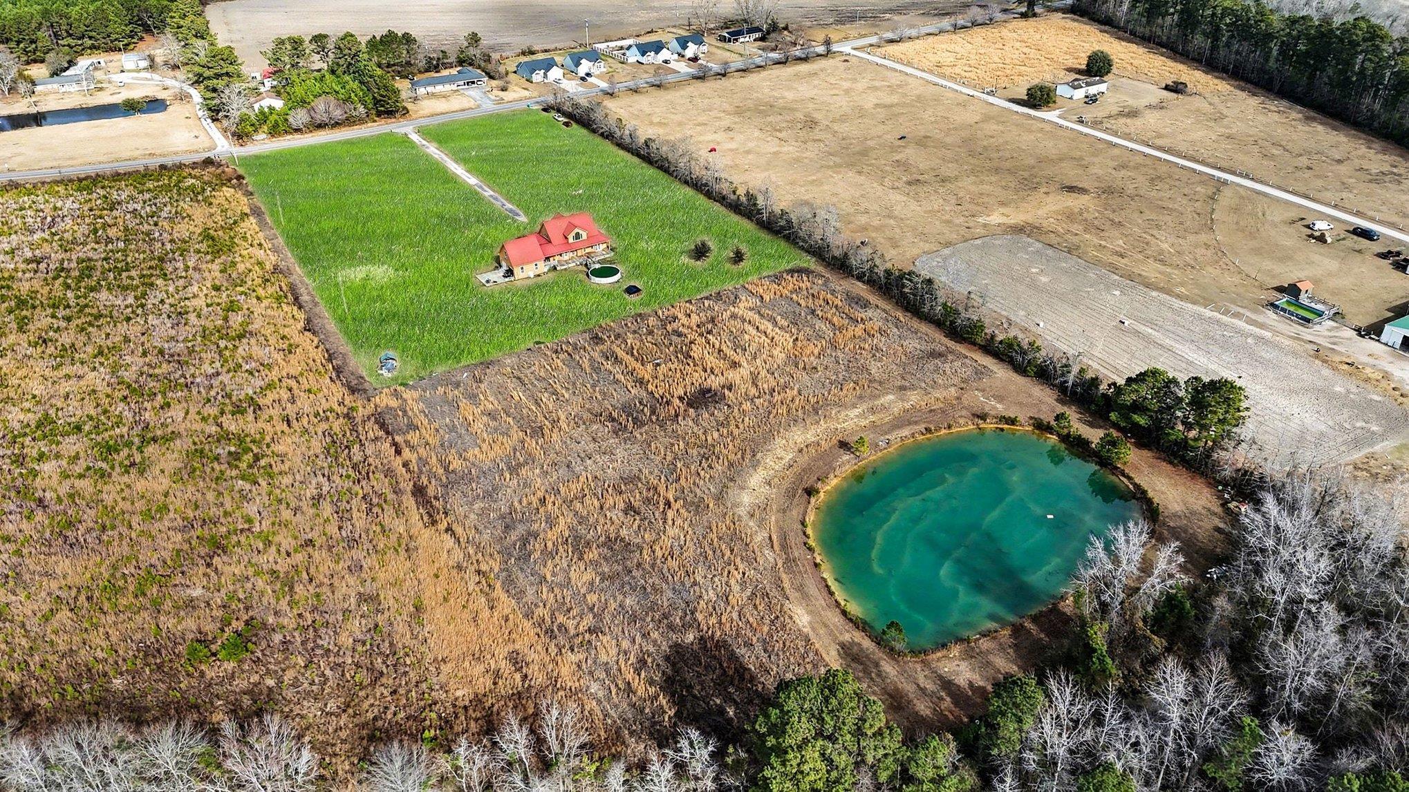 202 Highway 747 Loris Sc 29569 Loris, SC 29569 - Photo 31 of 34 Aerial view of sparsely populated area featuring a large pond