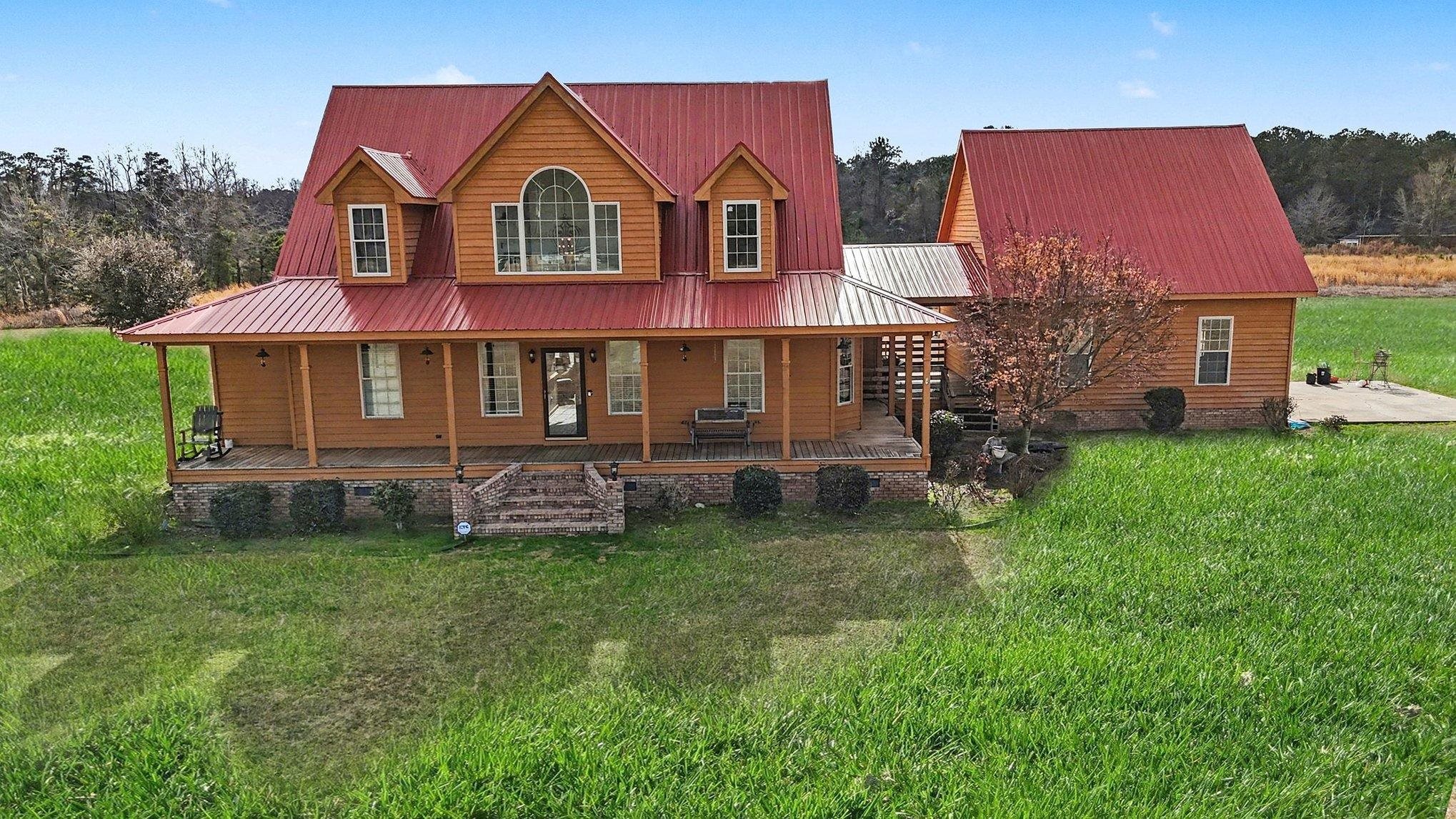 202 Highway 747 Loris Sc 29569 Loris, SC 29569 - Photo 34 of 34 View of front of property with covered porch, a front yard, and a metal roof