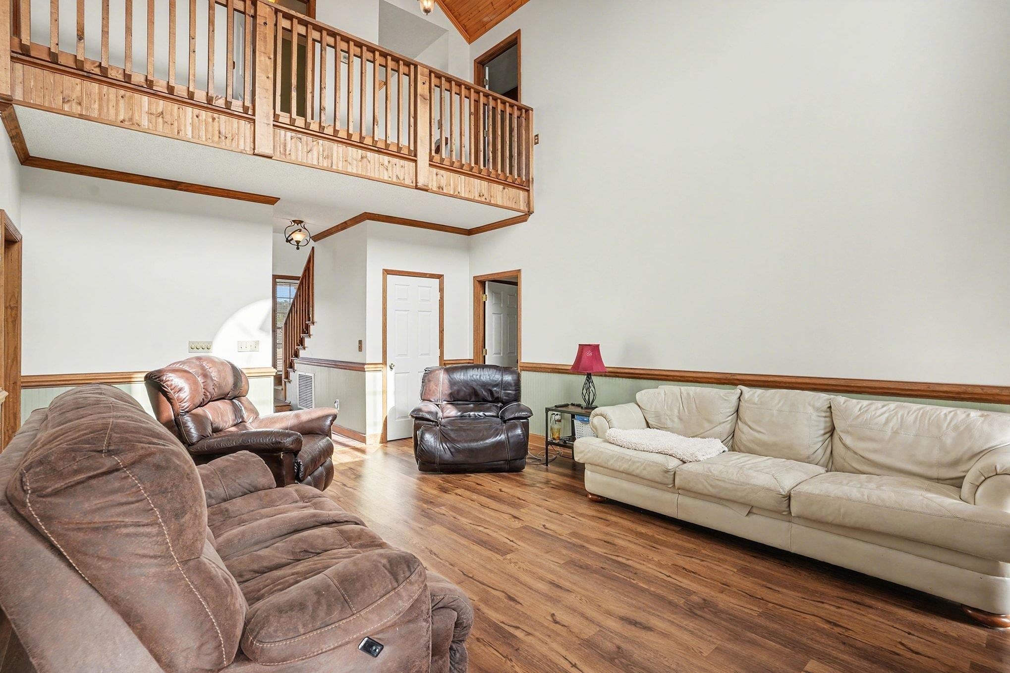 202 Highway 747 Loris Sc 29569 Loris, SC 29569 - Photo 6 of 34 Living area with a towering ceiling, wood finished floors, and stairs