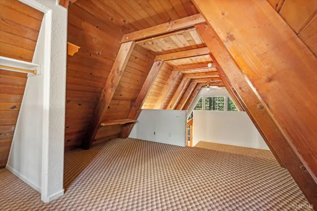 a view of a bedroom with wooden floor