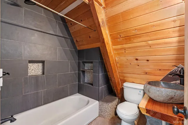 a bathroom with a toilet and shower