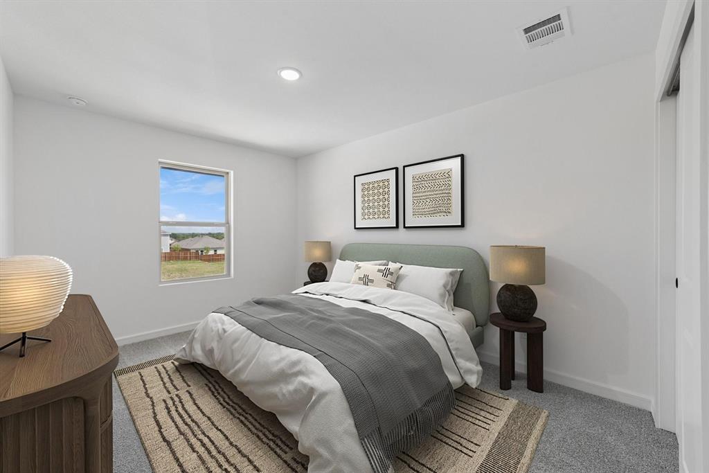 1412 Elliott Road Howe, TX 75459 - Photo 13 of 26 a bedroom with a bed and a painting on the wall