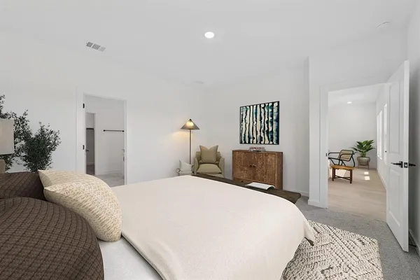 a bedroom with a bed and lamp