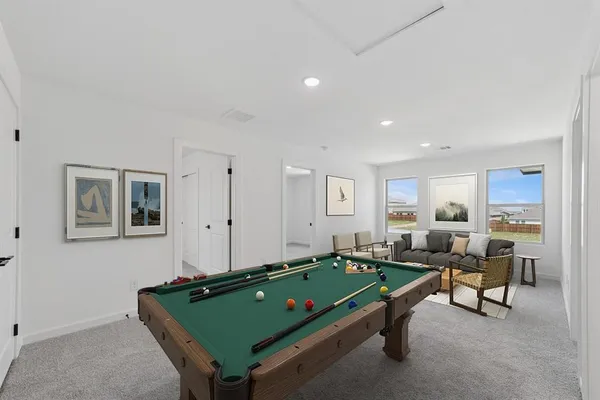 a room with furniture pool table and windows