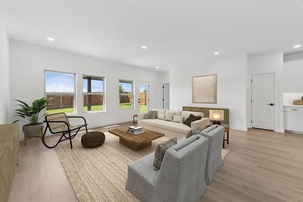 a living room with furniture and a wooden floor
