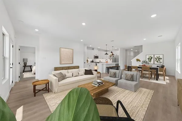 a living room with furniture or kitchen view and a wooden floor