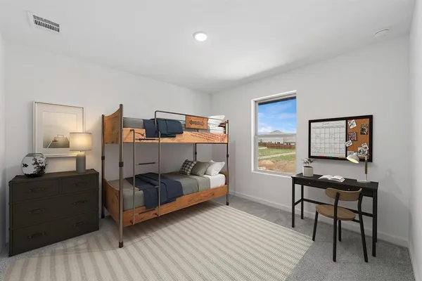 a bedroom with a bed and a desk