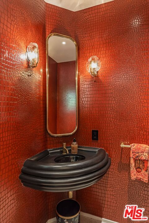 1070 North Hillcrest Road Beverly Hills, CA 90210 - Photo 12 of 29 a bathroom with a sink and mirror