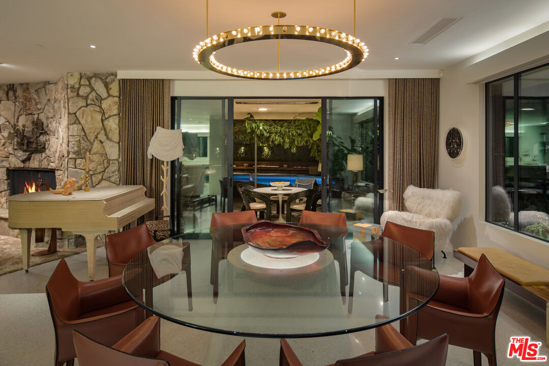 1070 North Hillcrest Road Beverly Hills, CA 90210 - Photo 21 of 29 a dining room with furniture a table and chairs