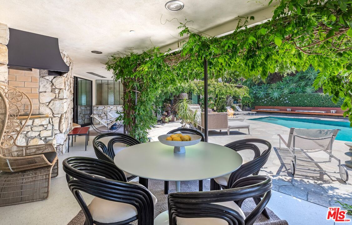 1070 North Hillcrest Road Beverly Hills, CA 90210 - Photo 22 of 29 a outdoor dining space with furniture and outdoor seating