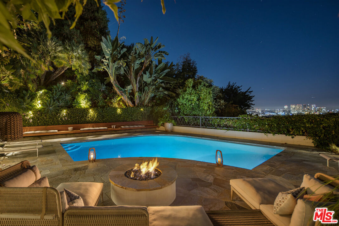 1070 North Hillcrest Road Beverly Hills, CA 90210 - Photo 29 of 29 a view of a swimming pool with lounge chair