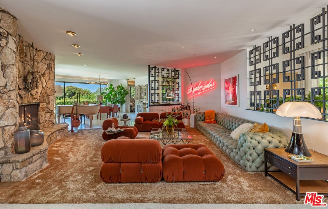 1070 North Hillcrest Road Beverly Hills, CA 90210 - Photo 4 of 29 a living room with furniture and a potted plant