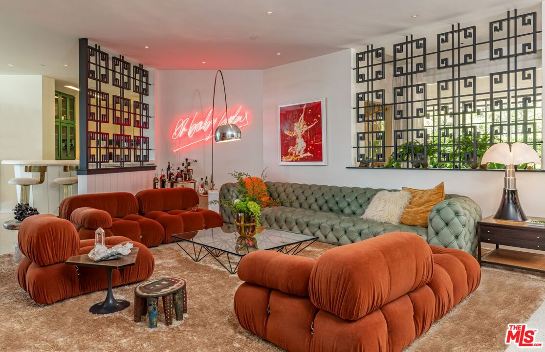 1070 North Hillcrest Road Beverly Hills, CA 90210 - Photo 5 of 29 a living room with furniture a rug and a wall painting