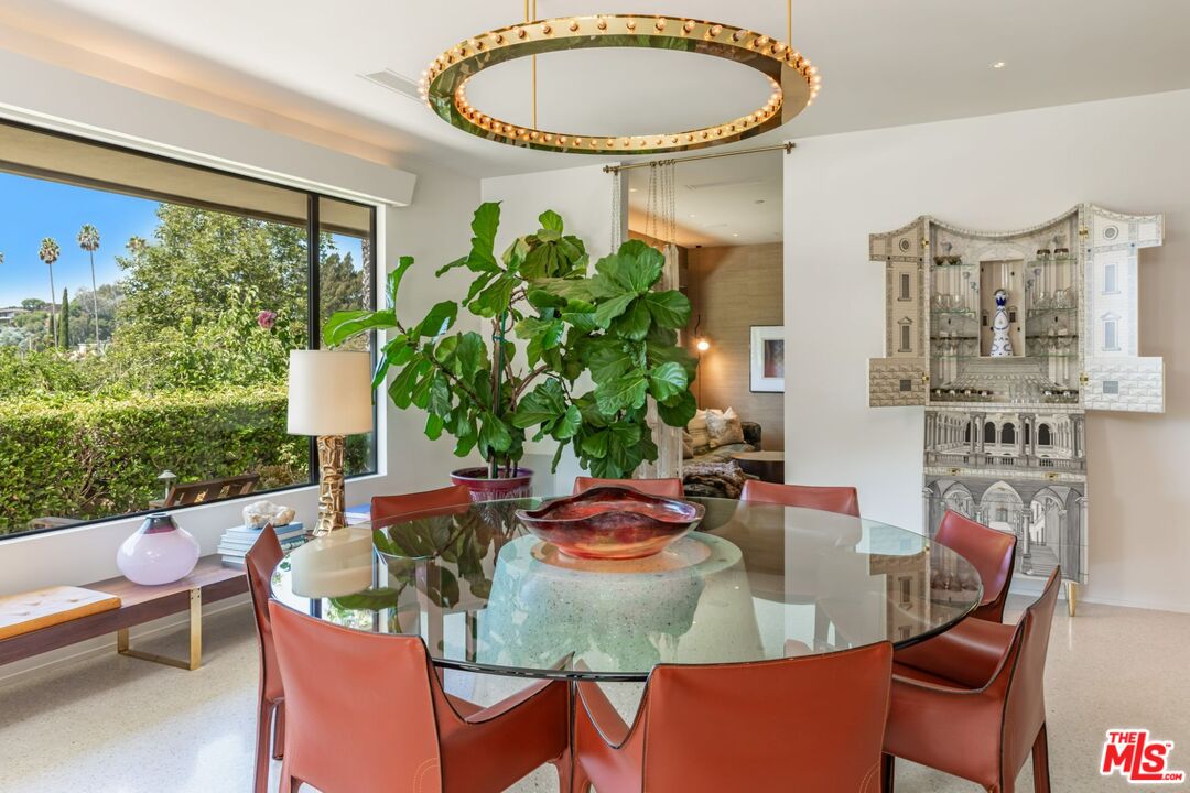 1070 North Hillcrest Road Beverly Hills, CA 90210 - Photo 7 of 29 a view of a dining room with furniture window and outside view