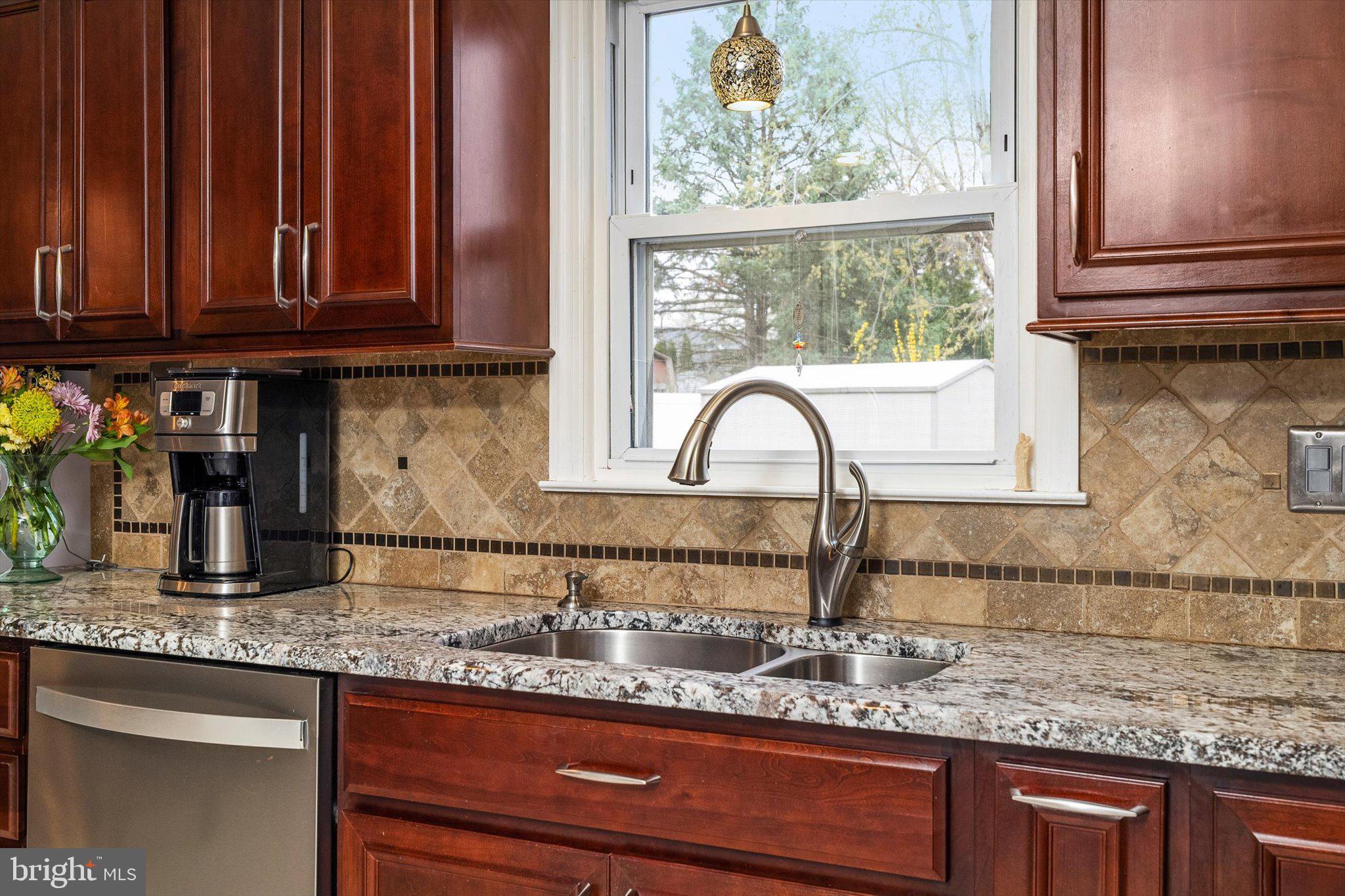22 Hoffman Drive Hamilton, NJ 08690 - Photo 13 of 34 a kitchen with granite countertop a sink and cabinets