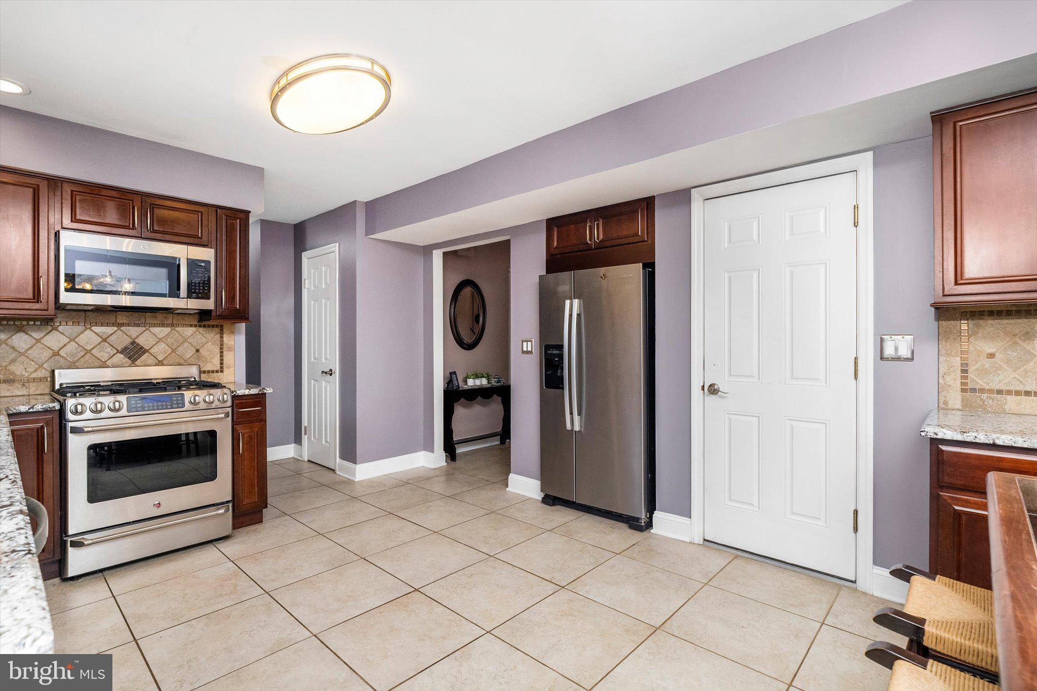 22 Hoffman Drive Hamilton, NJ 08690 - Photo 14 of 34 a kitchen with granite countertop a stove and a refrigerator