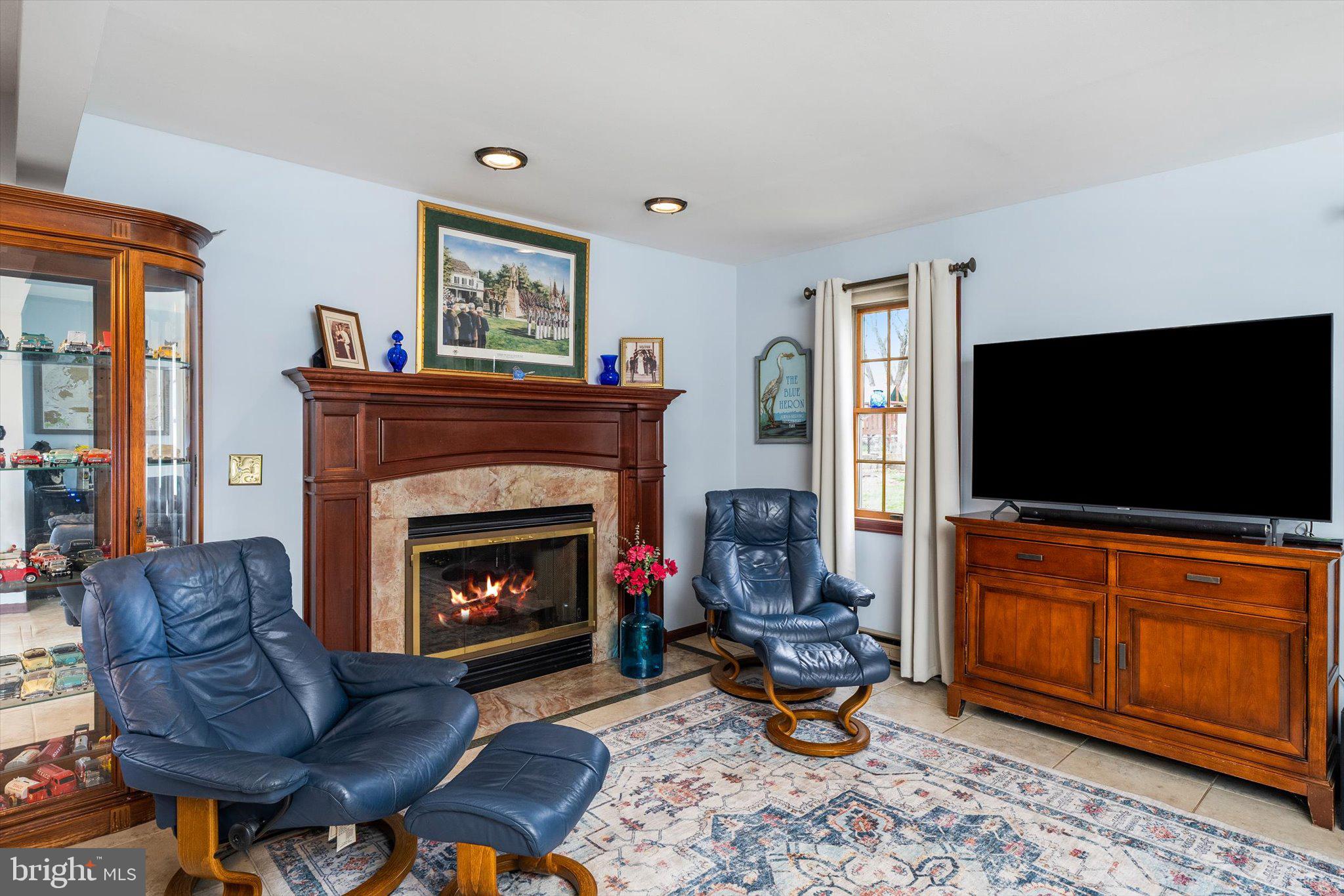 22 Hoffman Drive Hamilton, NJ 08690 - Photo 19 of 34 a living room with furniture a flat screen tv and a fireplace