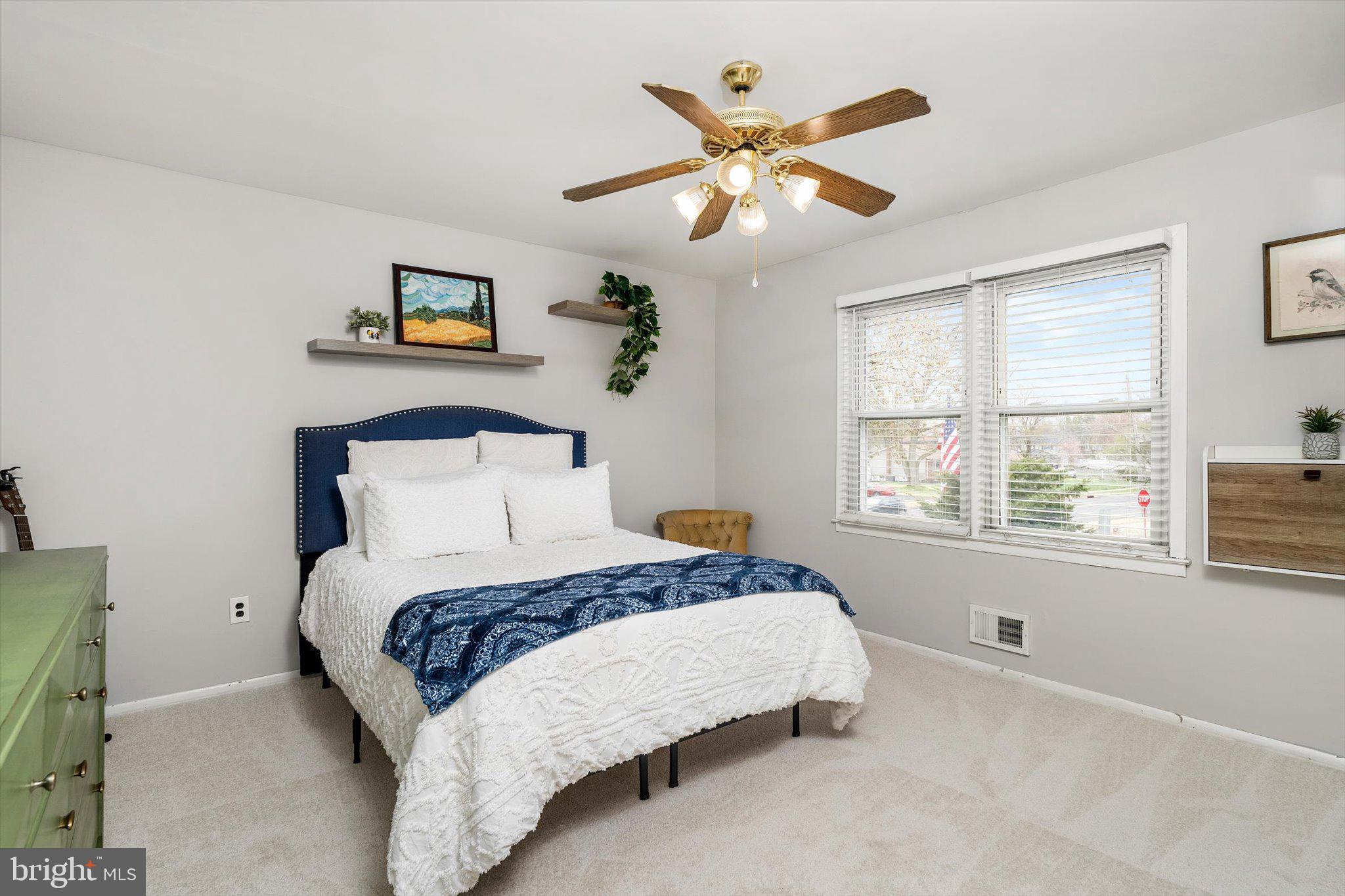 22 Hoffman Drive Hamilton, NJ 08690 - Photo 24 of 34 a bedroom with a large bed and a chandelier