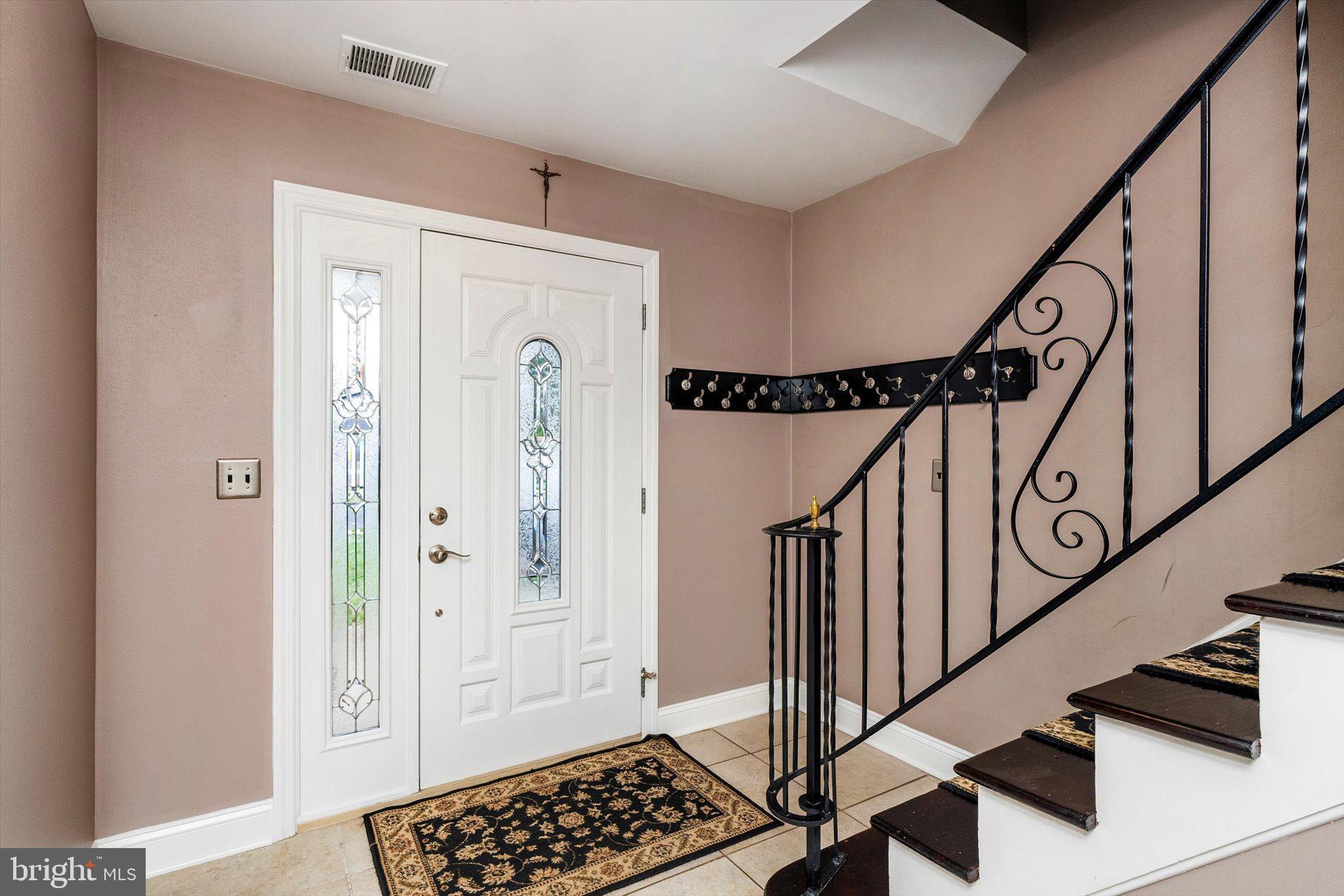 22 Hoffman Drive Hamilton, NJ 08690 - Photo 5 of 34 a view of an entryway with wooden floor and stairs