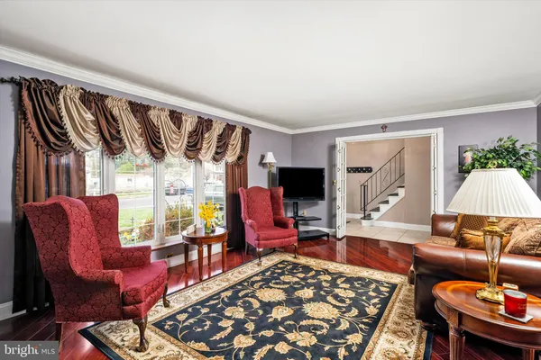 a living room with furniture a rug and a large window