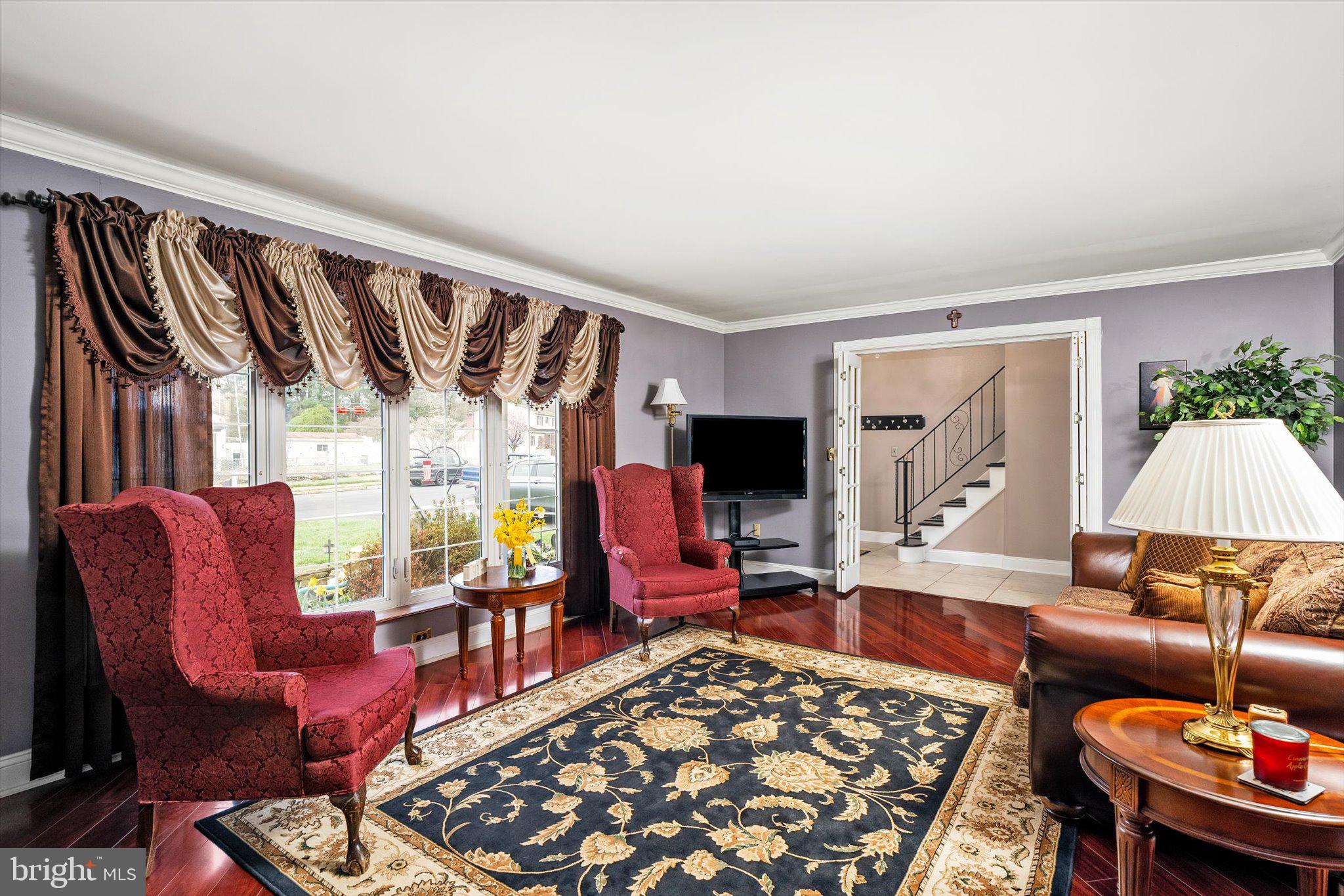 22 Hoffman Drive Hamilton, NJ 08690 - Photo 8 of 34 a living room with furniture a rug and a large window