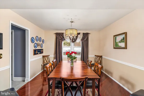 a view of a dining room with furniture and chandelier
