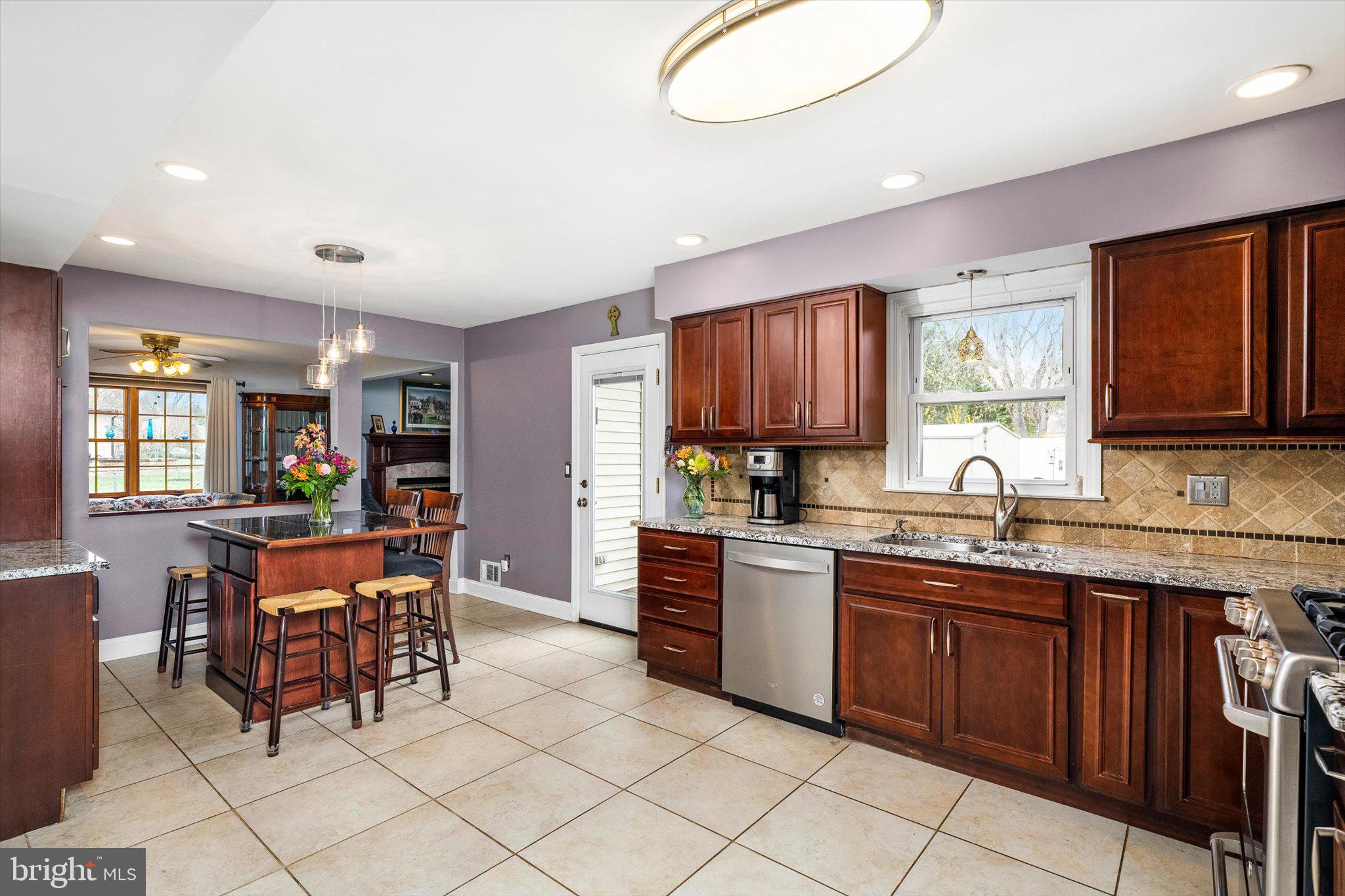 22 Hoffman Drive Hamilton, NJ 08690 - Photo 10 of 34 a kitchen with stainless steel appliances granite countertop table chairs sink and window