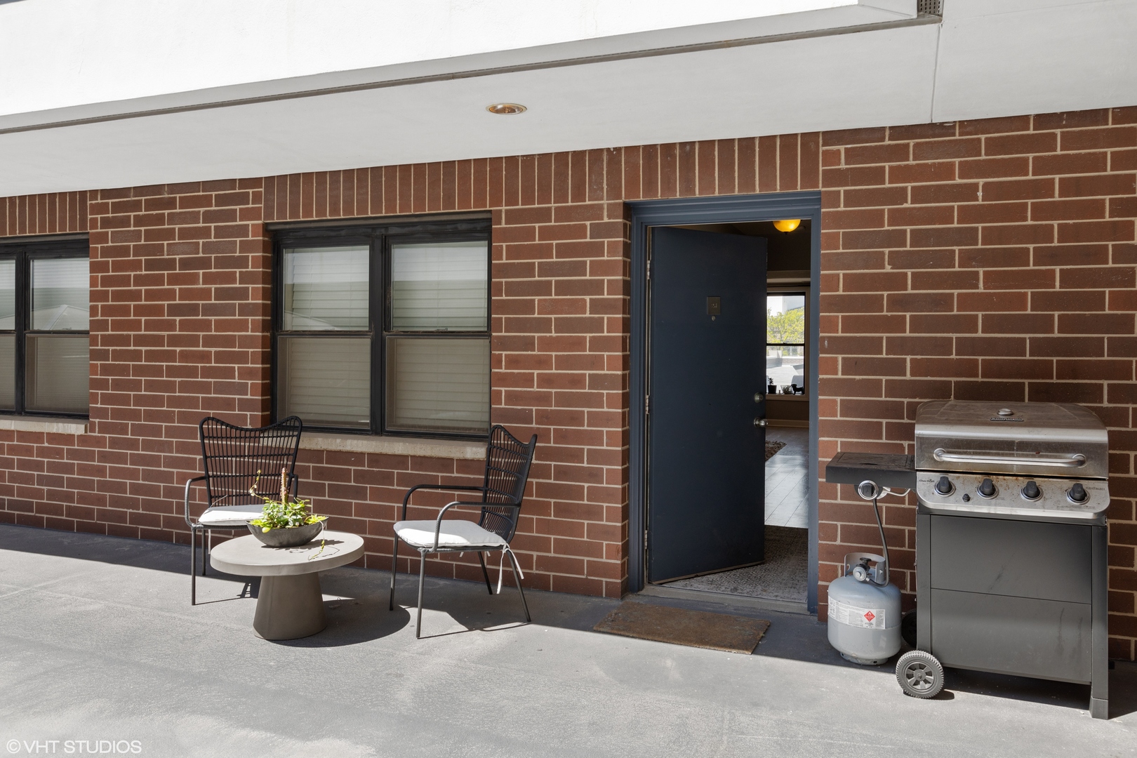 1600 North Halsted Street, Unit 2J Chicago, IL 60614 - Photo 3 of 13 a view of a fireplace with chair and potted plant