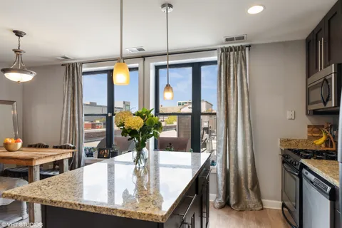 a kitchen with a table and chairs