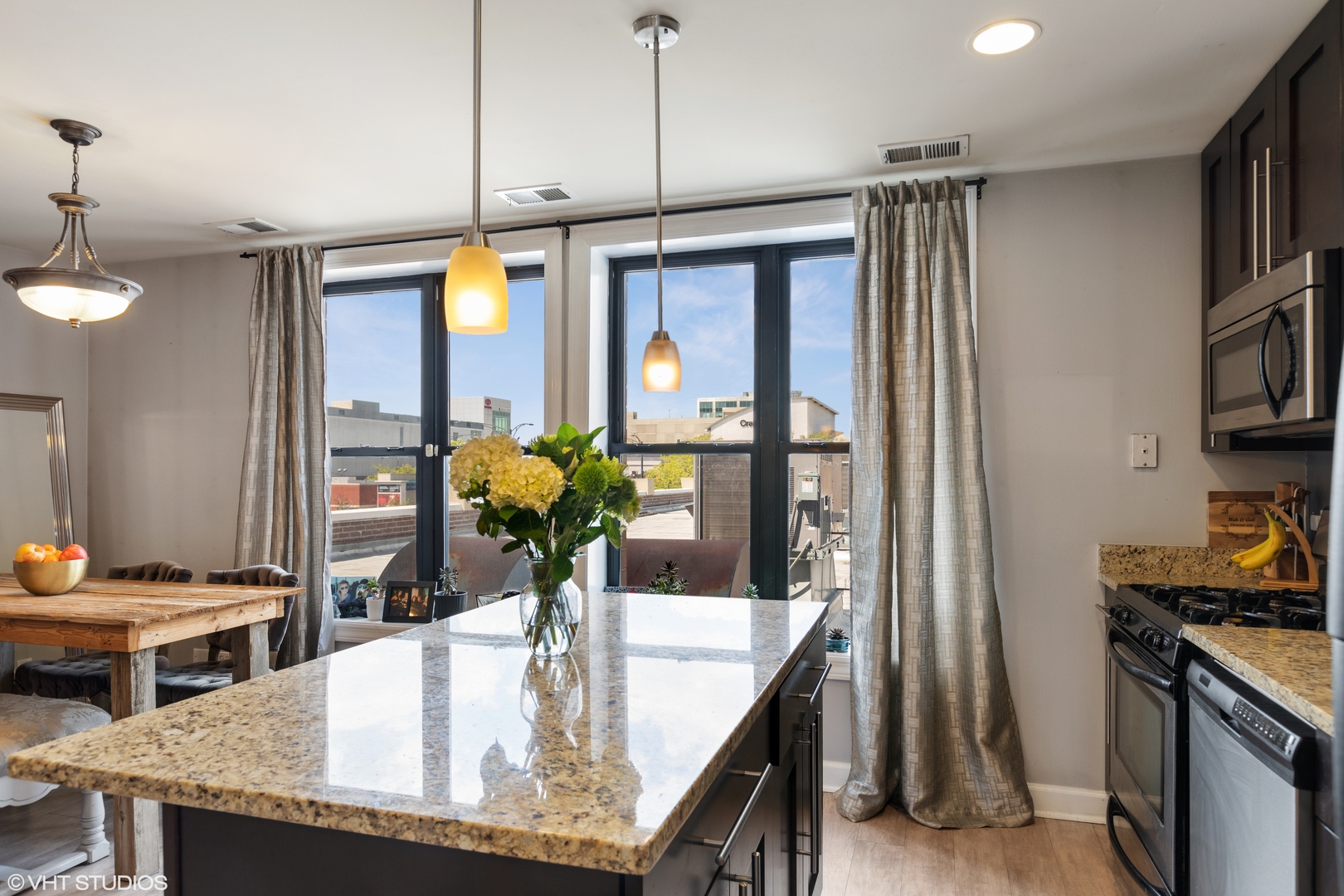 1600 North Halsted Street, Unit 2J Chicago, IL 60614 - Photo 4 of 13 a kitchen with a table and chairs