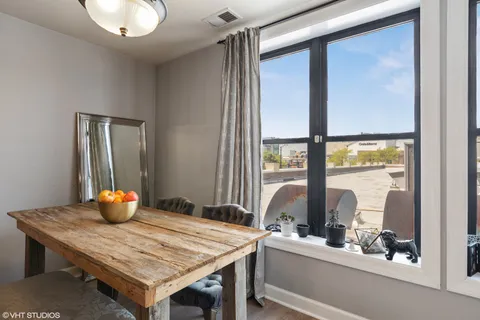 a kitchen with a wooden table and chairs