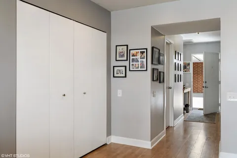 a view of a hallway with wooden floor