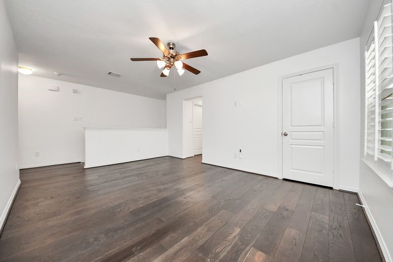4222 Drake Street Houston, TX 77005 - Photo 15 of 28 an empty room with wooden floor fan and windows