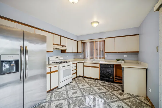 a kitchen with a sink stove and refrigerator