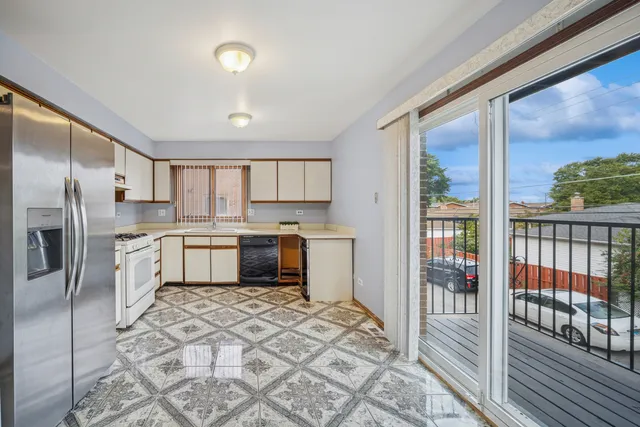 a kitchen with granite countertop a sink appliances cabinets and a counter top space