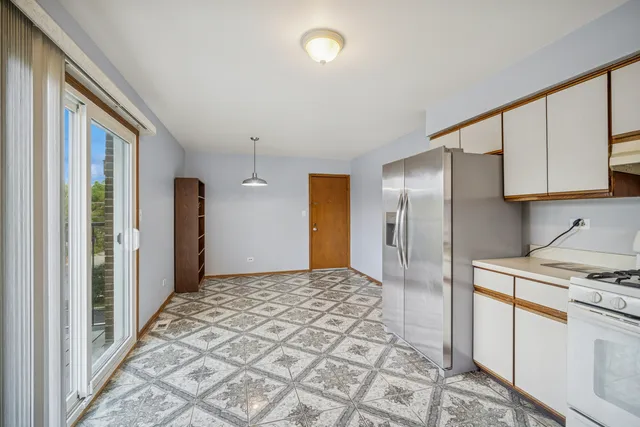 a kitchen with stainless steel appliances granite countertop a refrigerator and a stove top oven