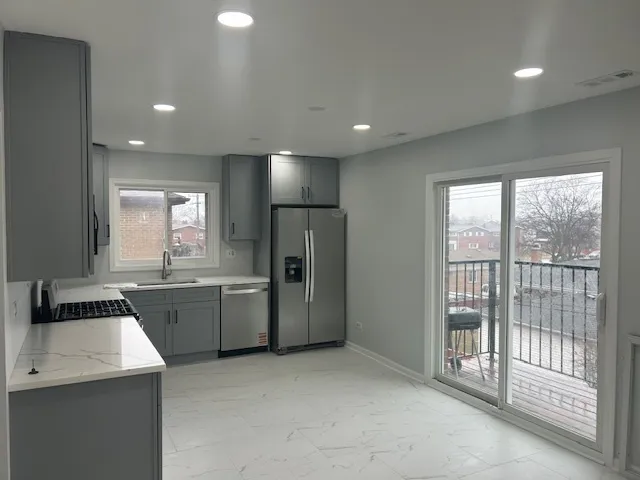 a kitchen with a sink and refrigerator