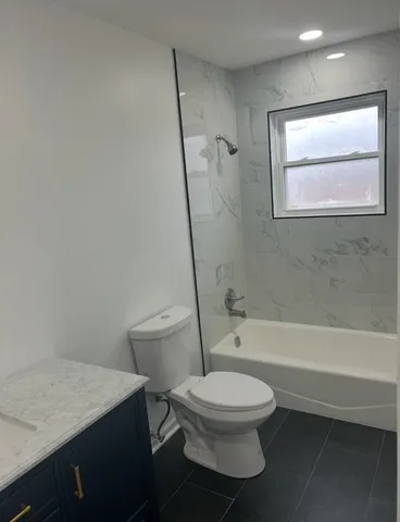 a bathroom with a toilet a sink and bathtub
